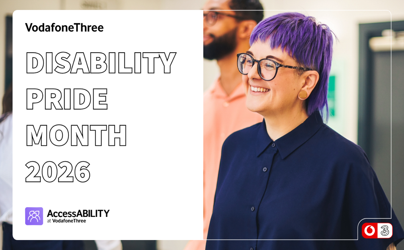 This image is a promotional graphic for Disability Pride Month 2026, co-branded by VodafoneThree. Here is a detailed breakdown of the image: Text and Branding (Left Side): Top Left: Bold text reading "VodafoneThree". Main Title: Large, outlined sans-serif font reading "DISABILITY PRIDE MONTH 2026". Bottom Left: A purple logo for "AccessABILITY at VodafoneThree", featuring an icon of three stylized figures within a rounded square. Visual/Subject (Right Side): Foreground: A person smiling broadly, facing towards the left. They have vibrant purple-dyed hair styled in a mullet with short bangs, tortoise-shell glasses, ear gauges/plugs, and are wearing a dark navy button-up shirt. Background: A blurred office environment with another individual standing behind them in a light orange button-up shirt and glasses. Bottom Right: A small combined logo box featuring the Vodafone speech mark and the Three logo side-by-side.