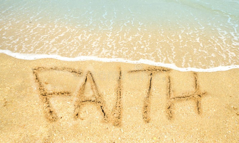 The word 'FAITH' drawn in sand on the beach