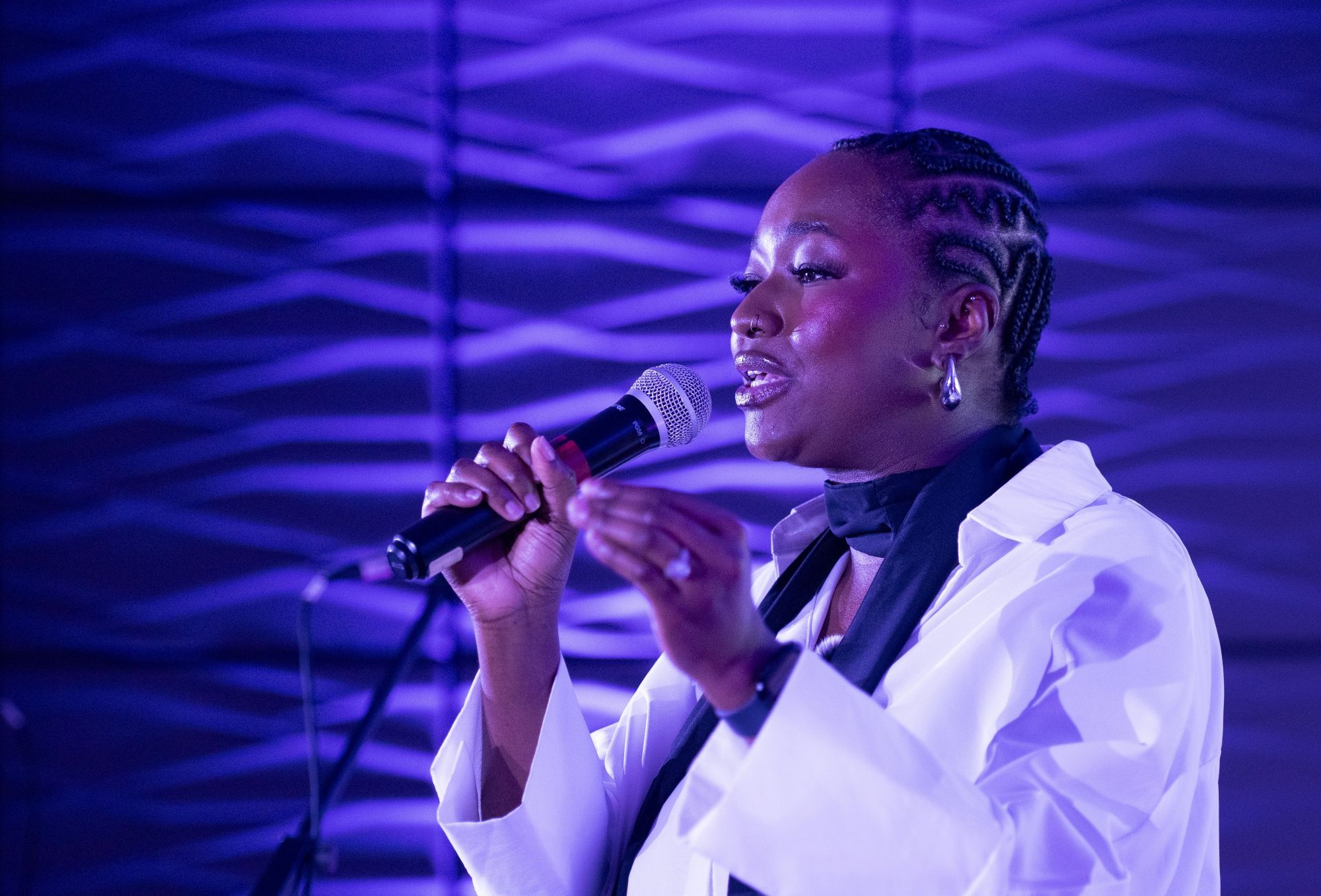 A black woman speaking into a micrphone