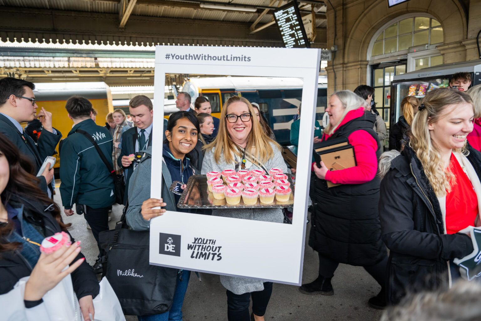 Staff members pose for a photo on the train platform