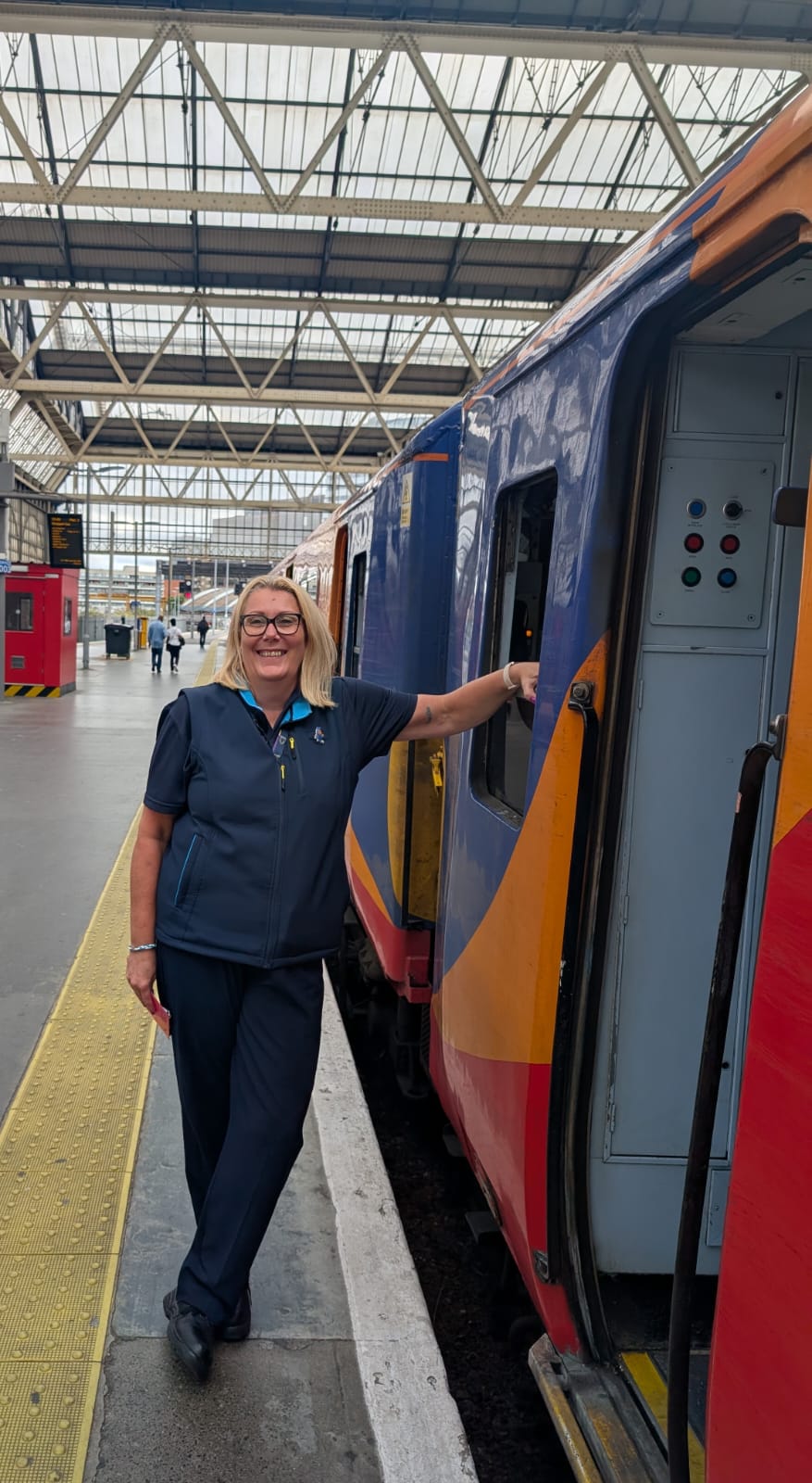 Suzanne standing next to a train