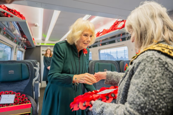 The Queen on a train accepting a poppy wreath