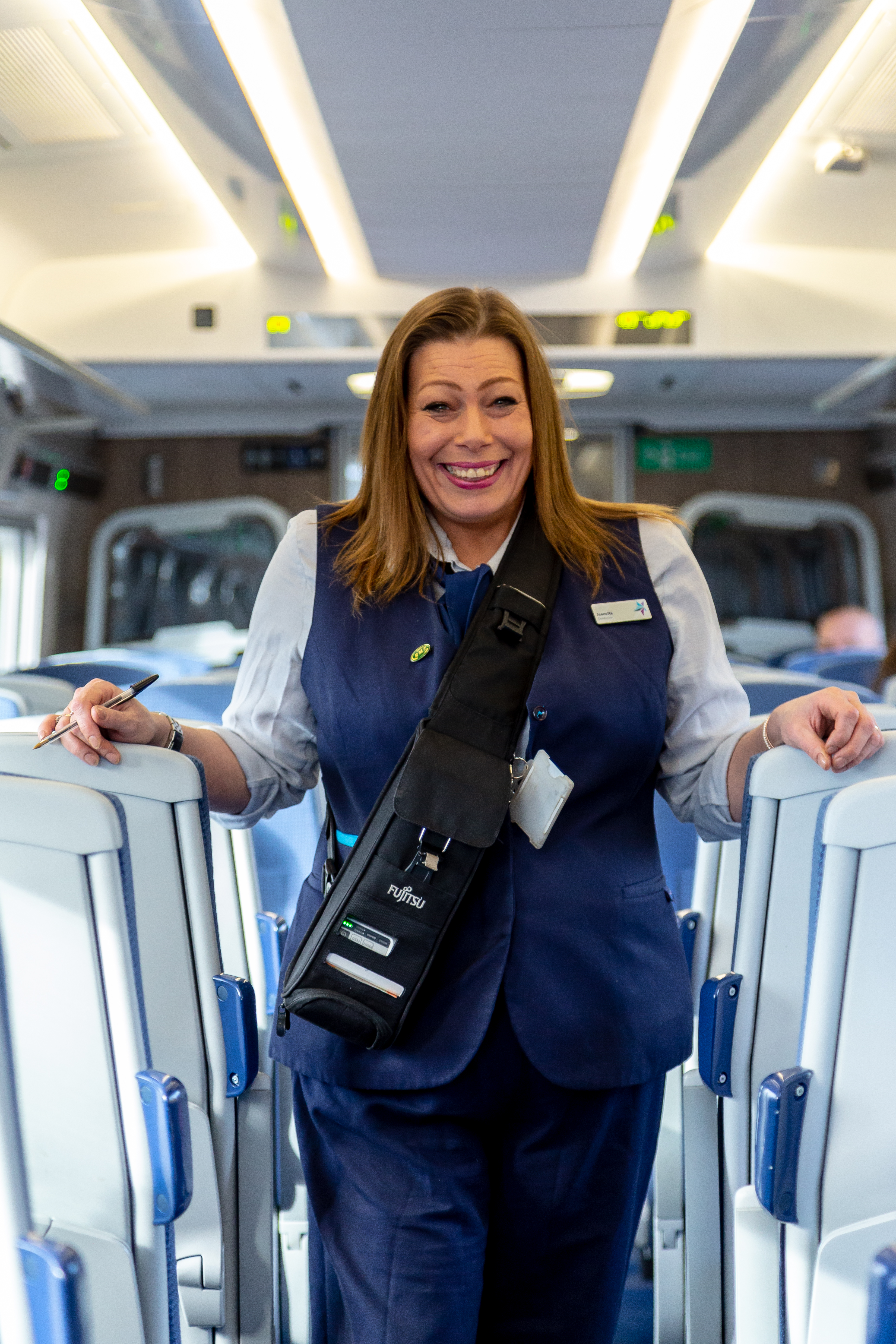 Female colleague on board of a TPE train © Jonny Walton 2022