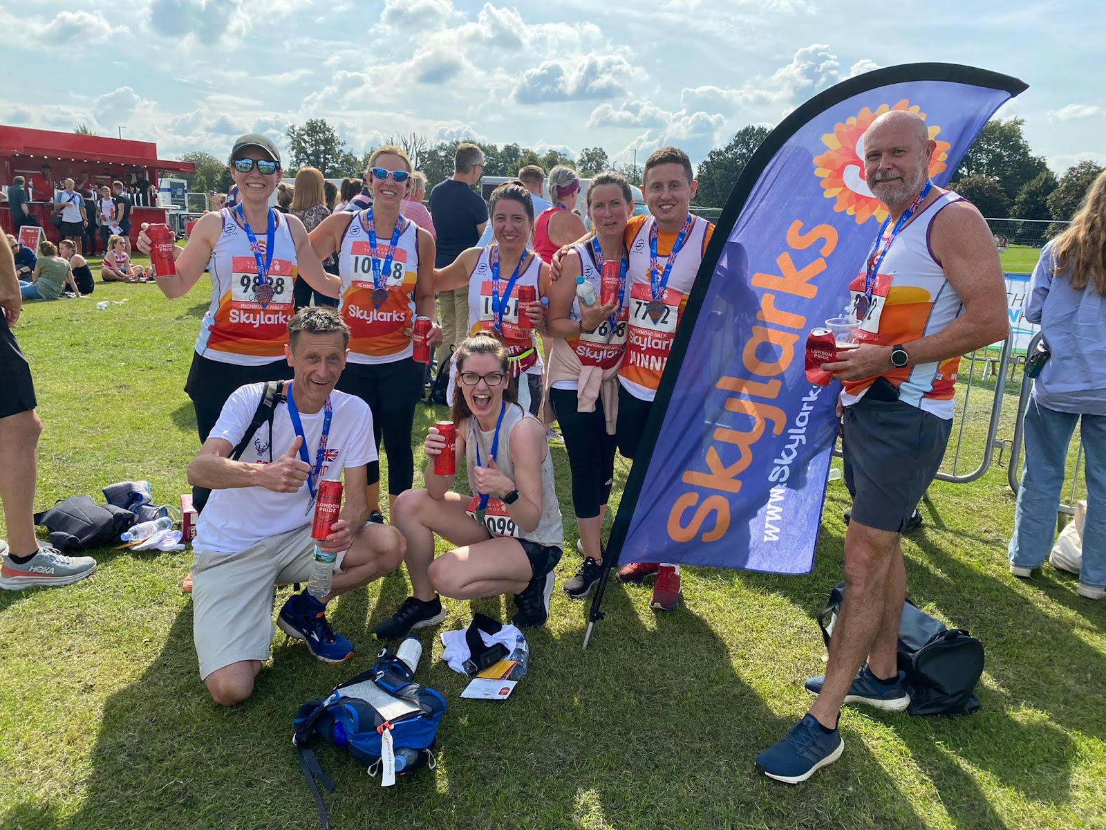 Picture of 8 individuals smiling at the camera having finished a run in Richmond park for charity