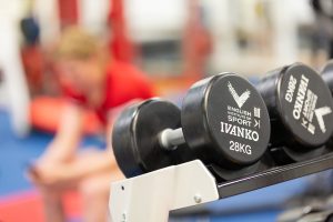 Image of 2 dumbbells' with English Institute of Sport written on them