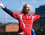 Female player celebrating scoring a goal.
