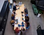 Ariel view of an office with people sat around a long table