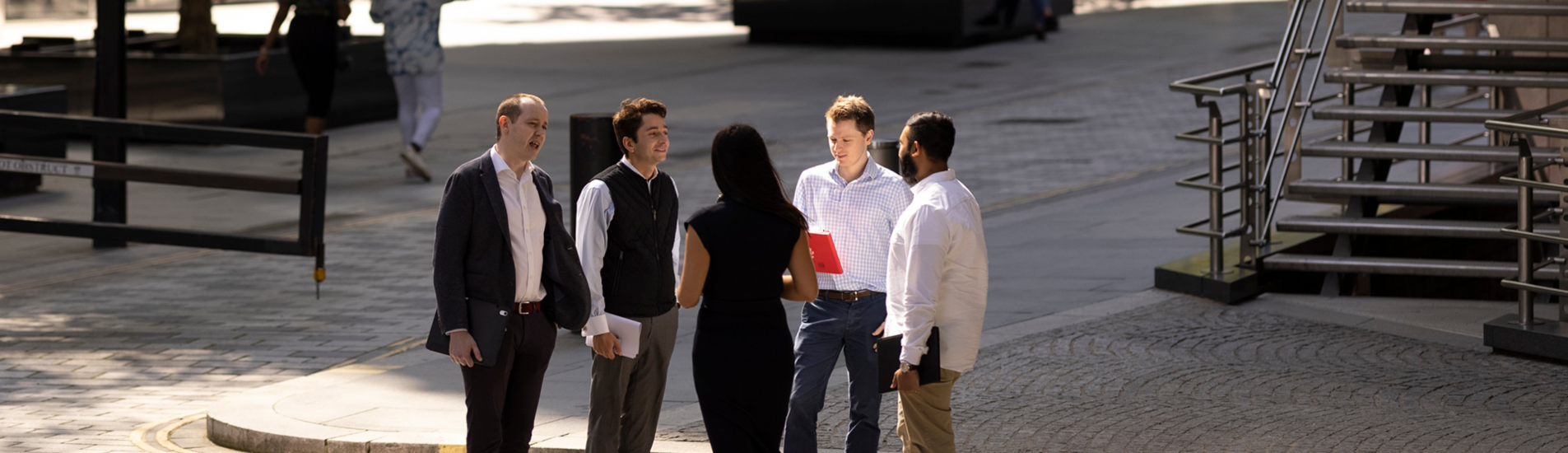 A group of Lloyd's employees outside their London office