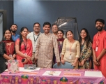 A group of Asian people, of mixed genders, dressed in traditional clothing celebrating Diwali