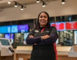 A female employee smiling with her arms crossed in front of her