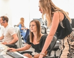 Two white women looking at a computer screen