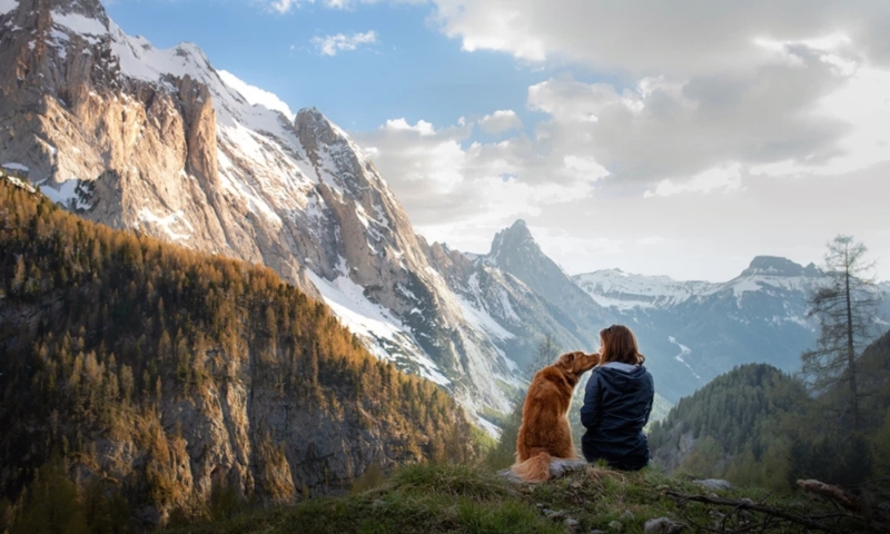 Dog and woman on mountain