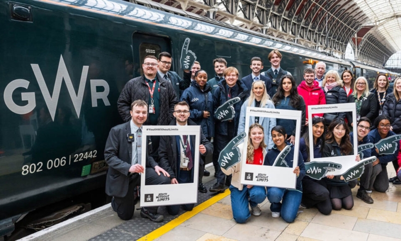GWR trainee train drivers pose for a group photo in front of a GWR train