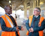 Two GWR collegues talking to each other on a train platform