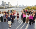 A group of diverse women collegues posing with Princess Anne