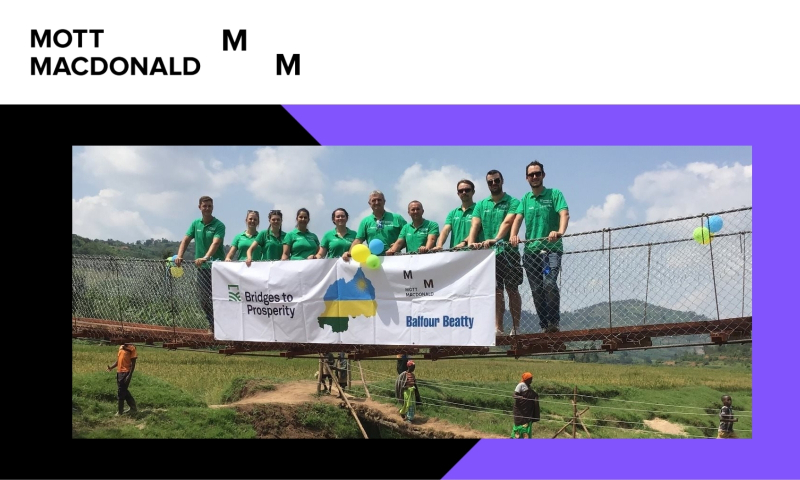 Mott Mac collegues in green thsirt standing on a bridge