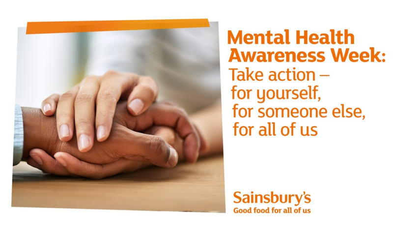 This image is a promotional graphic from the UK supermarket chain Sainsbury’s, created for Mental Health Awareness Week. The design is clean, professional, and aims to evoke a sense of empathy and community support.  Visual Composition The image is split into two primary sections:  Left Side (Imagery): A close-up, high-quality photograph showing three hands joined together on a wooden surface. One person’s hands are gently placed over another’s in a gesture of comfort and solidarity. The diversity of the hands (different skin tones) suggests inclusivity and shared human experience.  Right Side (Text): Bold, orange text on a white background that delivers the core message.  Key Messaging & Text The text is organized with a clear hierarchy:  Headline: "Mental Health Awareness Week:" in a bold, sans-serif font.  Call to Action: "Take action – for yourself, for someone else, for all of us." This phrasing emphasizes personal responsibility and collective wellbeing.  Branding: In the bottom right corner, the Sainsbury’s logo appears with their slogan, "Good food for all of us."  Color Palette and Tone Primary Color: Orange, which is the signature brand color for Sainsbury's. It is used for the text and a decorative diagonal bar at the top left.  Tone: The overall feel is supportive and grounded. By using a soft-focus background and natural lighting, the image avoids looking "corporate" and instead feels warm and approachable.