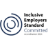 The image features an accreditation logo for Inclusive Employers Standard set against a plain white background.   Iconography: On the left, there is a dark blue abstract symbol composed of several concentric, broken circular arcs swirling towards the centre.   Text: To the right of the icon, the text is arranged vertically in four lines:   Inclusive Employers Standard appears in a bold, black sans-serif font across the top three lines.   Committed is written underneath in a lighter, slate-grey, larger sans-serif font.   Accreditation 2024 is displayed in smaller, lighter grey text at the bottom.