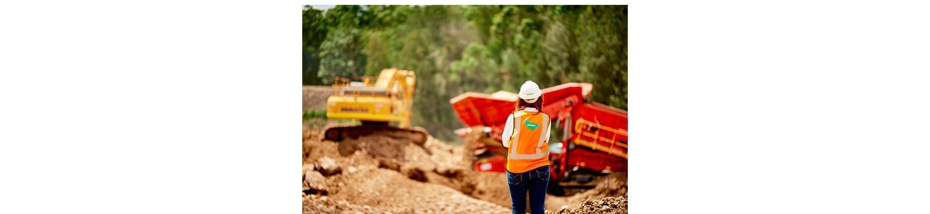 How Lendlease celebrated International Women in Engineering Day a woman standing on a building site, wearing a hard hat and a Lendlease high-visibility jacket.