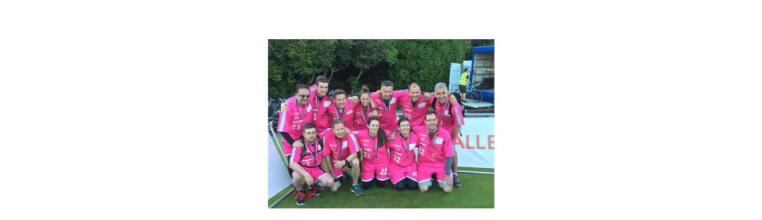 T-Systems employees who took part in the UK Challenge 2017. They are wearing magenta outfits and medals. 